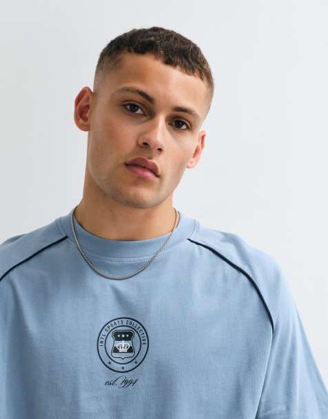 ASOS DESIGN – Blå, panelsydd t-shirt i oversized fit med boxig passform och sportigt tryck - view 1