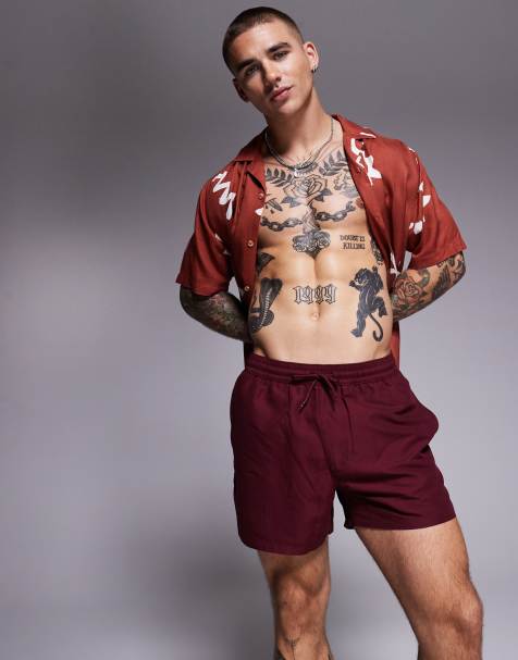 ASOS DESIGN swim shorts in short length in burgundy