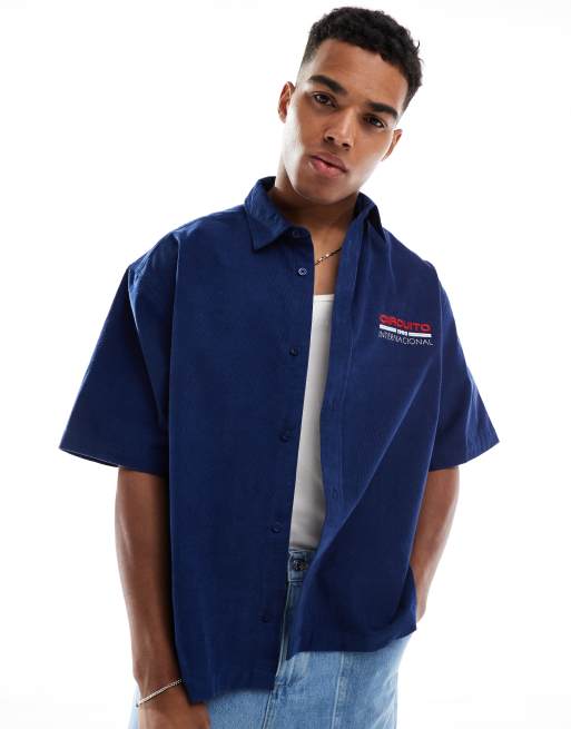 ASOS DESIGN boxy oversized cord shirt with chest print in navy