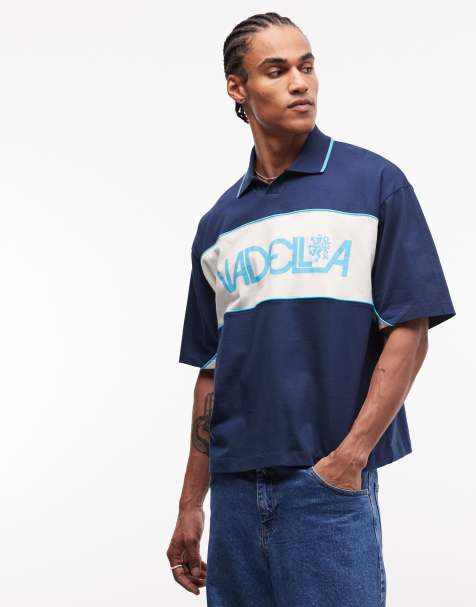 ASOS DESIGN boxy oversized polo shirt with cut and sew paneling and sports graphic in dark blue - view 1