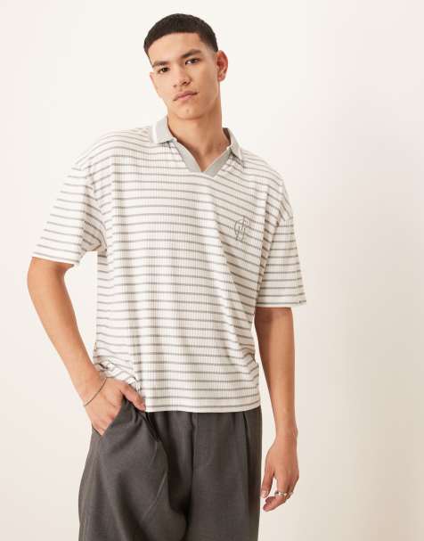 ASOS DESIGN boxy oversized polo with chest logo in blue and white ribbed stripe