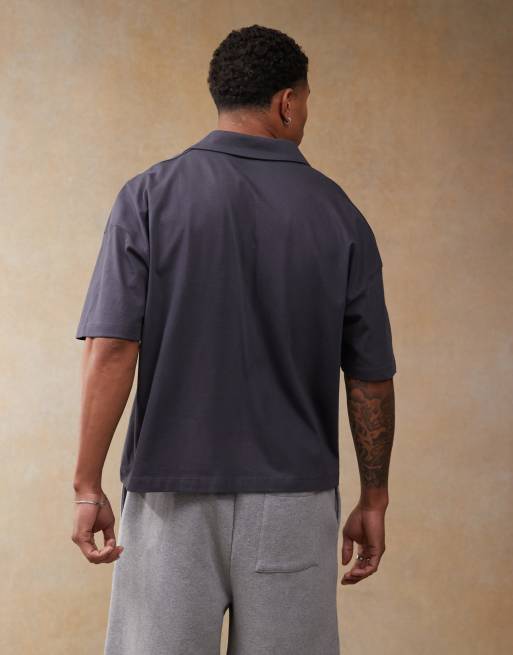 ASOS DESIGN boxy oversized polo with dropped shoulder and multiplacement sport print in navy