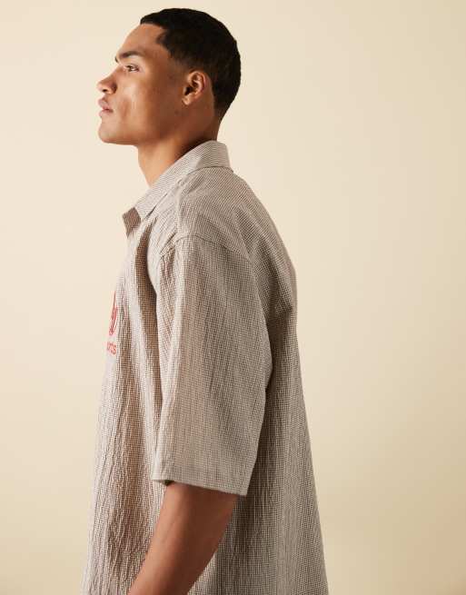 ASOS DESIGN boxy oversized shirt in brown plaid with chest embroidery
