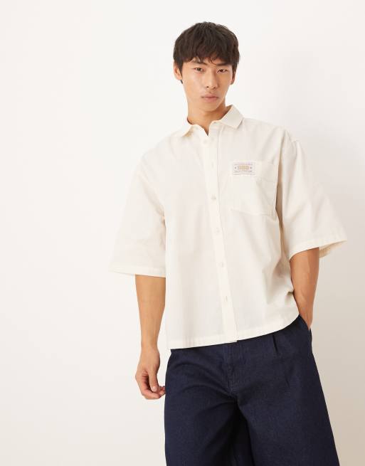 ASOS DESIGN boxy oversized shirt with chest badge in beige