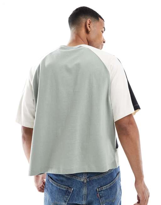 ASOS DESIGN boxy oversized T-shirt with cut and sew paneling and sports graphics in sage green