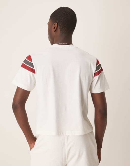 ASOS DESIGN boxy T-shirt with paneling and sports graphic in white