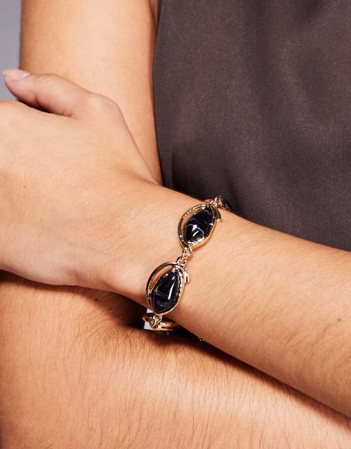 ASOS DESIGN - Bracciale a catenina dorato con pietre semipreziose sintetiche color blu navy incastonate