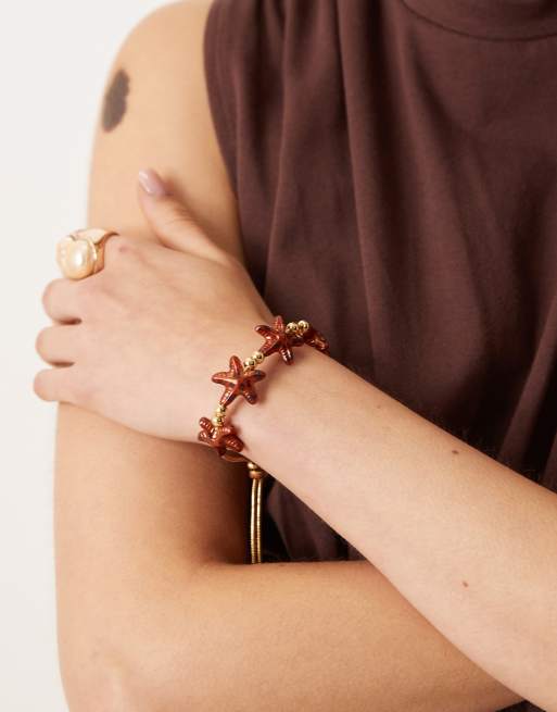 ASOS DESIGN - Bracciale dell'amicizia color oro con stelle marine tartarugate