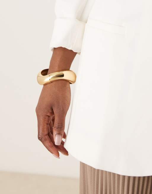 ASOS DESIGN - Bracciale rigido oro con dettaglio attorcigliato