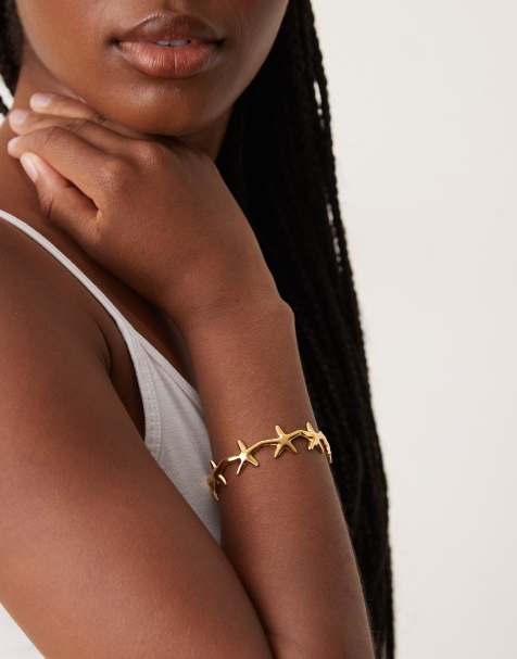 ASOS DESIGN - Bracelet jonc en acier inoxydable étanche avec petite étoile de mer - Doré - view 1