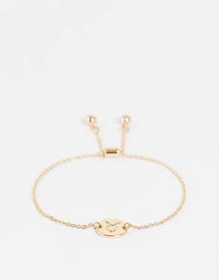 ASOS DESIGN bracelet with Taurus zodiac charm in gold tone