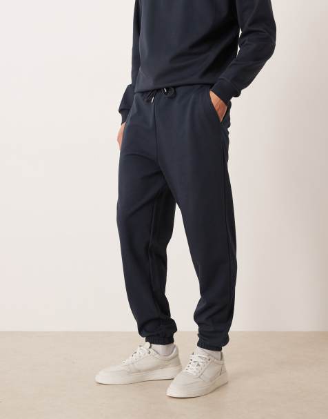 ASOS DESIGN – breatheMAX™ – Jogginghose in Marineblau mit schmal zulaufendem Bein, Kombiteil - view 1