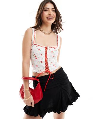 ASOS DESIGN broderie bust cup corset vest top with contrast lace up detail in cherry print-Multi