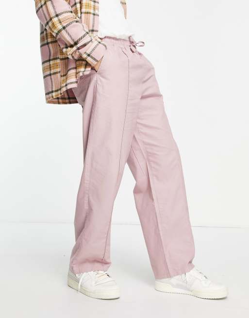ASOS DESIGN - Broek met wijde pijpen met plat gestikte plooitjes in roze