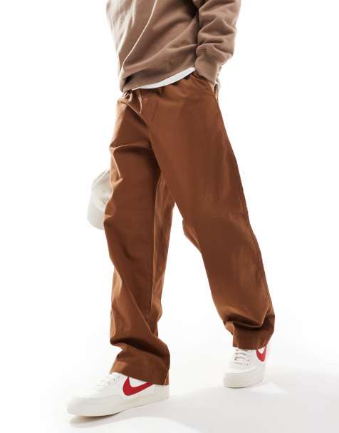 ASOS DESIGN – Bruna byxor i baggy-stil med elastisk midja och påsydd ficka - view 1