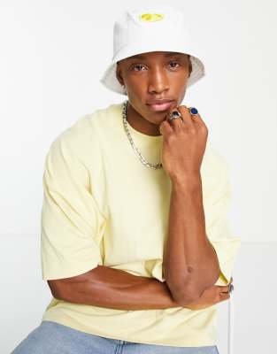 ASOS DESIGN bucket hat in white with lemon embroidery