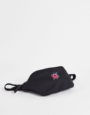 ASOS DESIGN bum bag in black nylon with smile embroidery