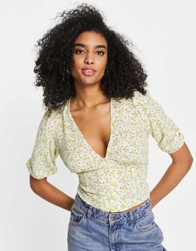 ASOS DESIGN button front tea blouse with volume sleeves and tie back detail in yellow ditsy print