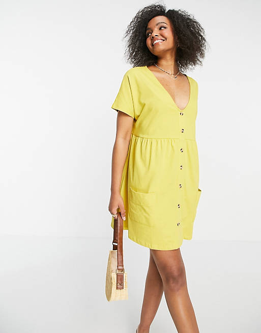 Women button through mini smock dress with pockets in mustard 