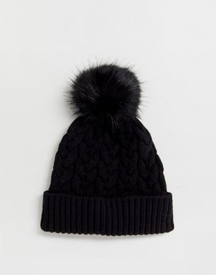 black wooly hat with fur pom pom