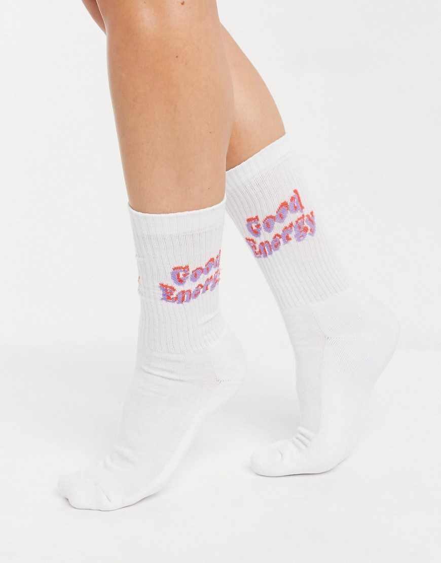 ASOS DESIGN calf length rib socks with good energy logo in white