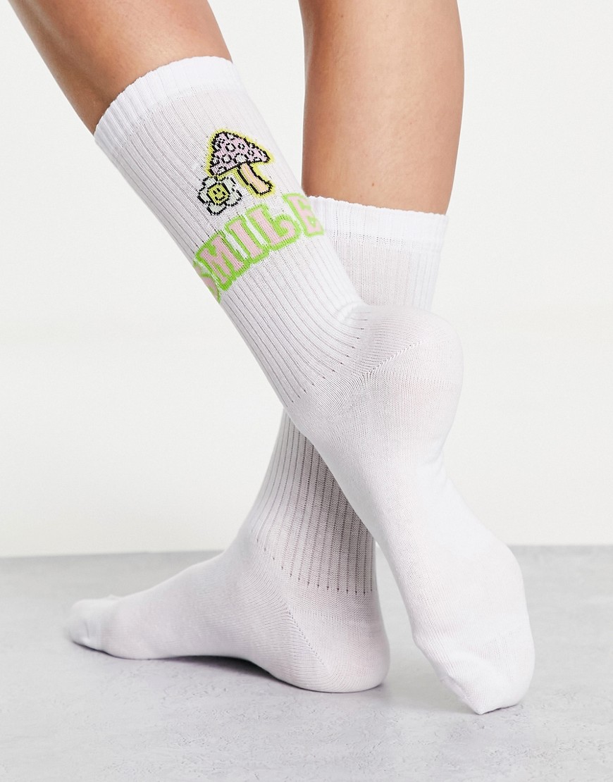 ASOS DESIGN calf length rib socks with mushroom and happy face motif in white