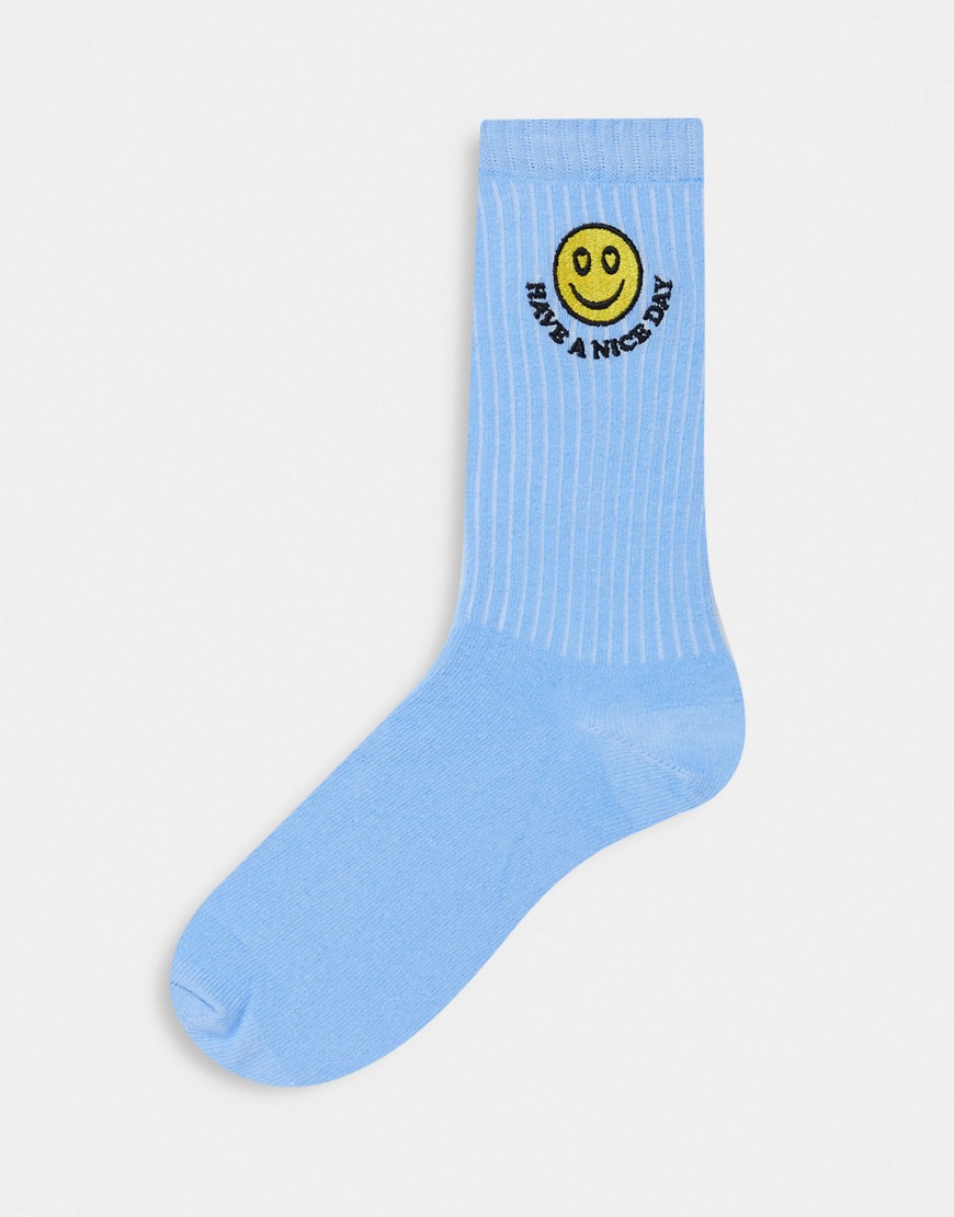 ASOS DESIGN calf length socks with happy face embroidery in blue-White