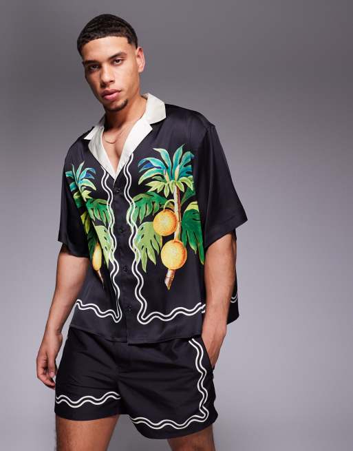 ASOS DESIGN - Camicia nera squadrata oversize con rever profondo e stampa di frutta sui bordi in coordinato