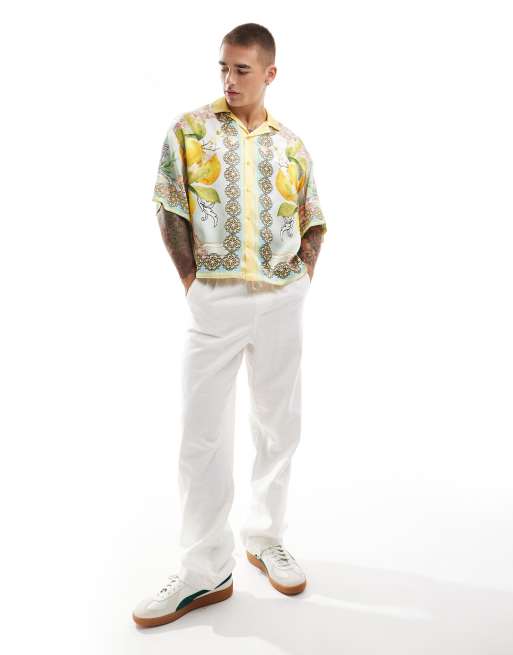 ASOS DESIGN - Camicia oversize squadrata in raso multicolore con stampa di agrumi sui bordi 