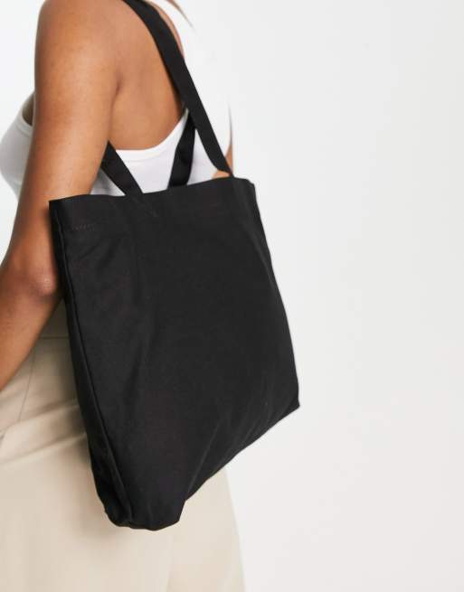 ASOS DESIGN canvas tote bag with laptop compartment in black