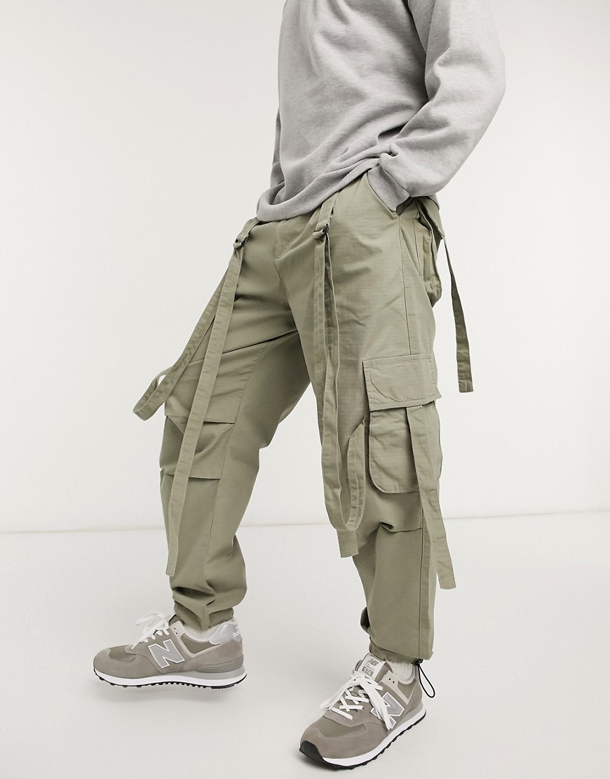 ASOS DESIGN cargo pants in green with strapping