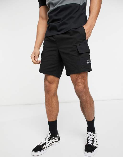 ASOS DESIGN cargo shorts in black with print