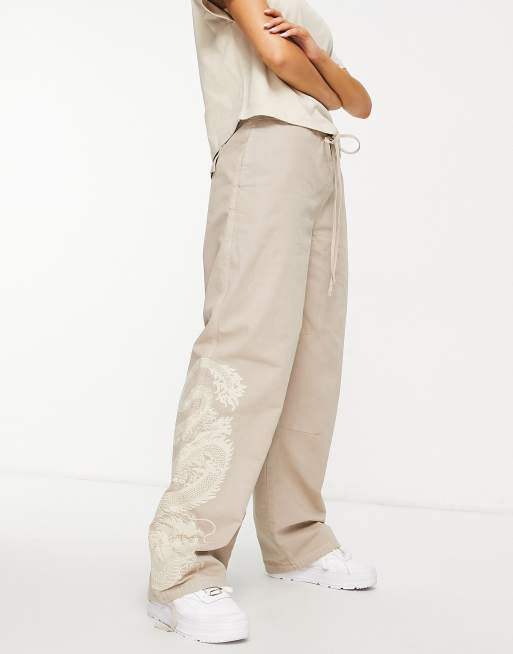 ASOS DESIGN - Cargobroek van parachutestof met geborduurde draak in kaki