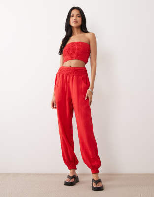 ASOS DESIGN cheesecloth shirred sweatpants in red