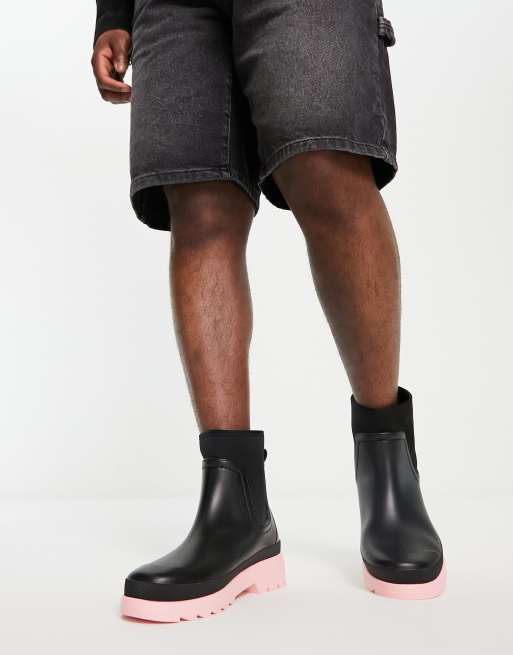 ASOS DESIGN chelsea gumboots in black with pink contrast sole