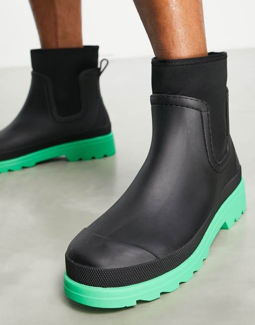 ASOS DESIGN chelsea wellington boot in black with green contrast sole