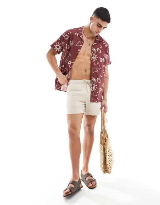 ASOS DESIGN - Chemise décontractée en aspect lin avec col à revers et imprimé signes astrologiques - Rouge 