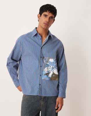 ASOS DESIGN - Chemise oversize en popeline rayée avec détail imprimé - Bleu