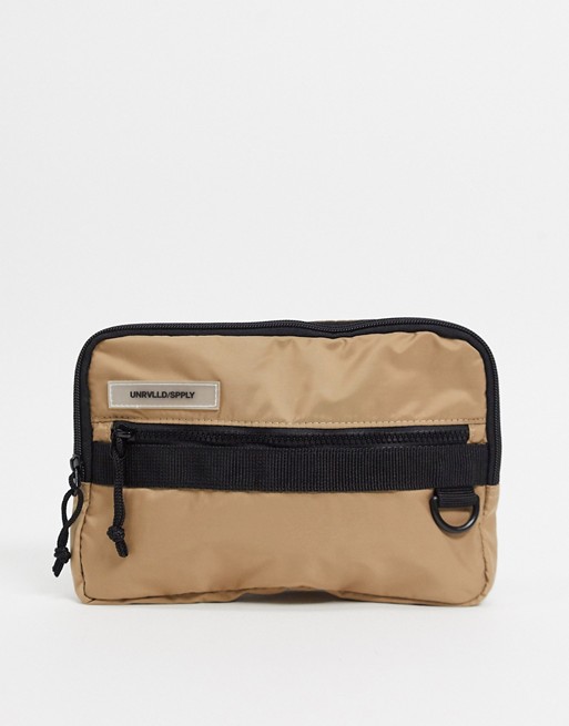 ASOS DESIGN chest harness bag in tan with rubberised slogan patch