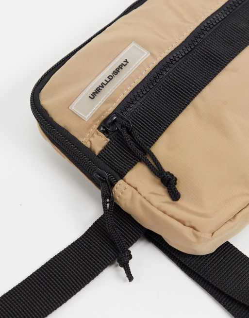 ASOS DESIGN chest harness bag in tan with rubberised slogan patch