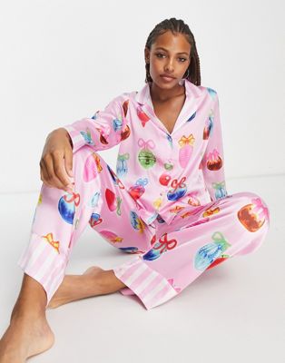 ASOS DESIGN Christmas bauble satin shirt & trouser pyjama set with contrast stripe cuffs in pink