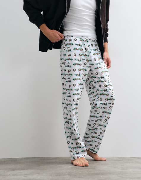 ASOS DESIGN Christmas pyjama bottoms with festive village graphic in white - view 1