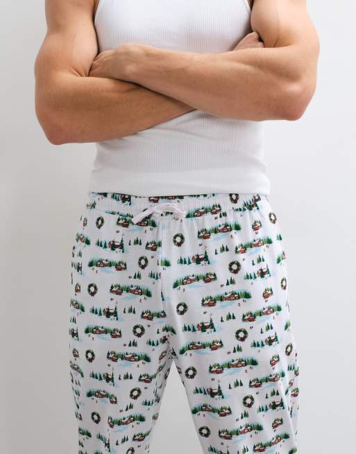 ASOS DESIGN Christmas pyjama bottoms with festive village graphic in white, 3 of 5
