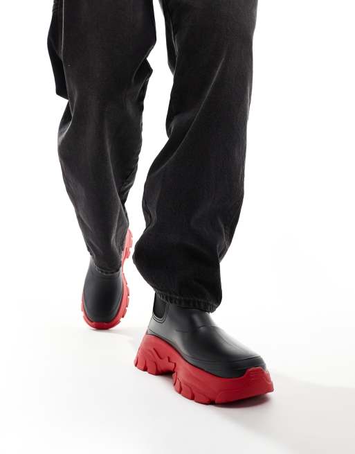 ASOS DESIGN chunky gumboots in black with contrast sole in red ASOS