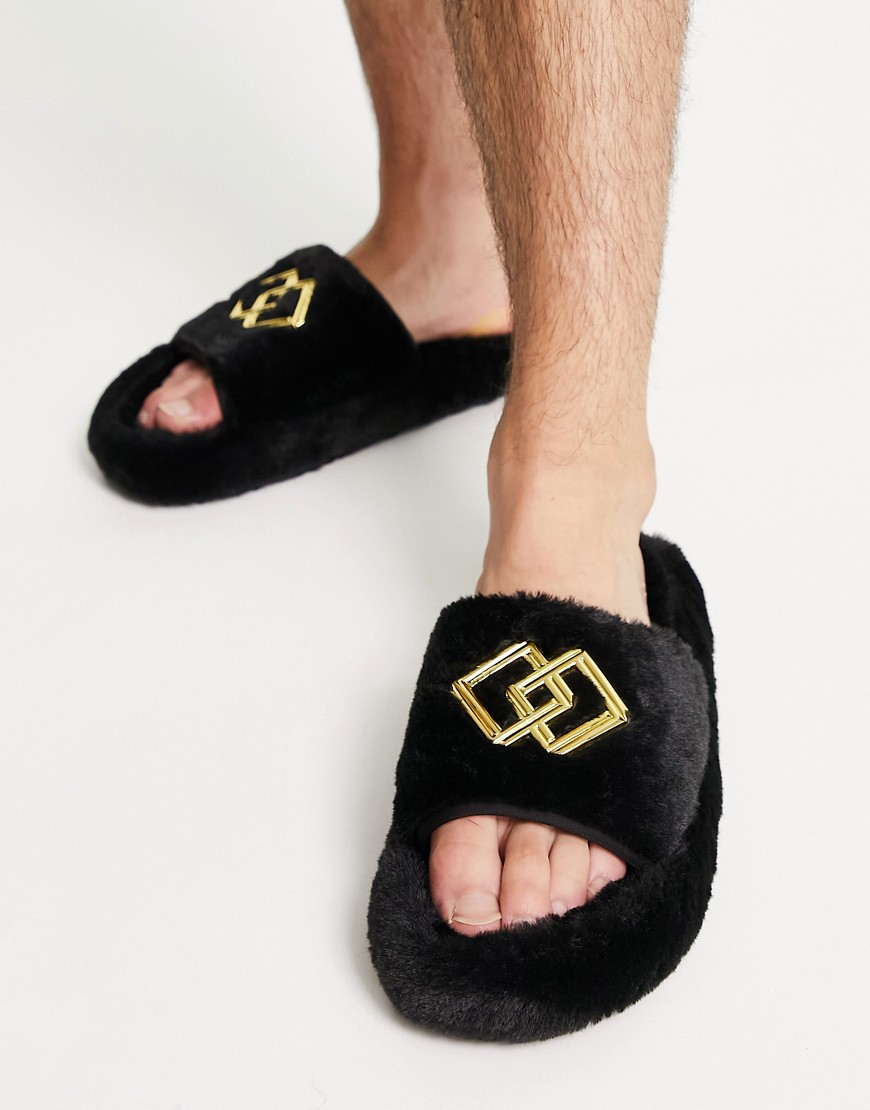 ASOS DESIGN chunky slippers in black faux fur with gold badge