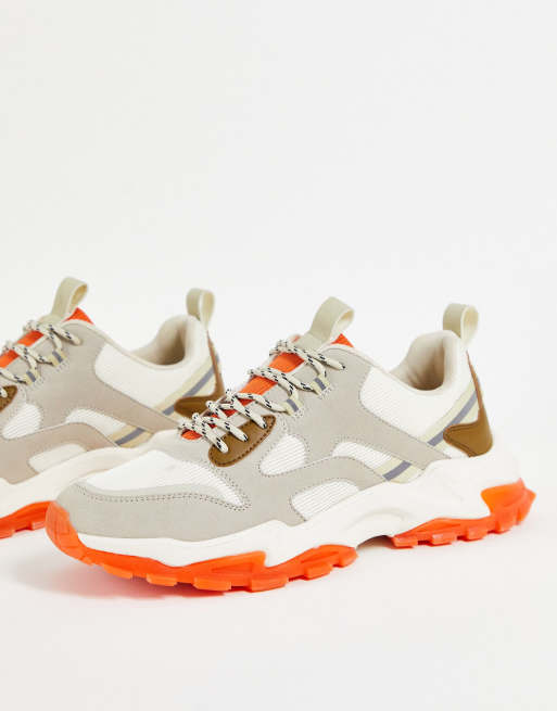 ASOS DESIGN chunky trainers in beige with tech detail and orange sole ...