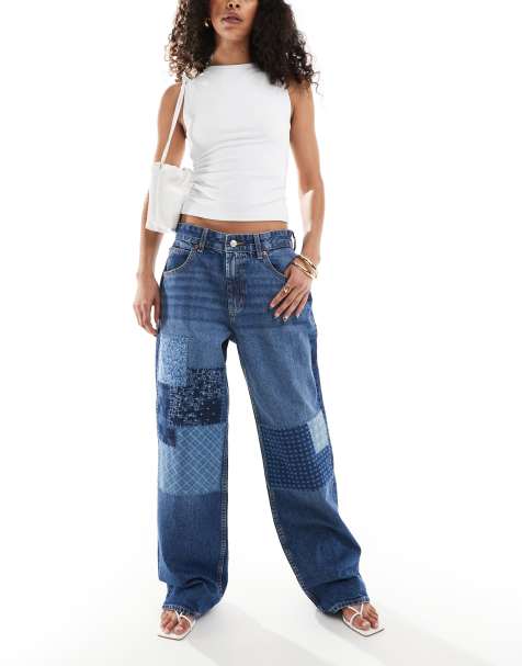 ASOS DESIGN – Ciemnoniebieskie jeansy baggy z obniżonym stanem w patchworkowy kwiatowy wzór - view 1