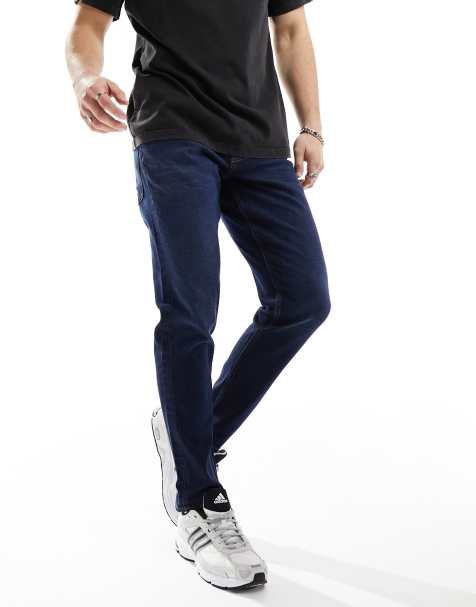 ASOS DESIGN - Ciemnoniebieskie jeansy ze spranego denimu ze stretchem o fasonie ze zwężanymi nogawkami - view 1