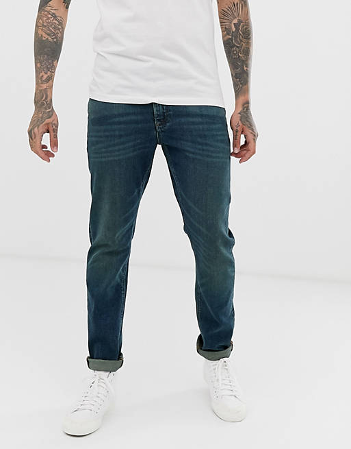 ASOS DESIGN - Ciemnoniebieskie jeansy ze spranego denimu ze stretchem w stylu vintage o obcisłym kroju