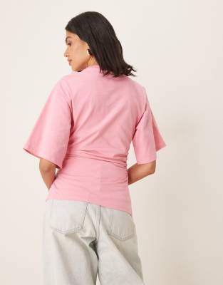 ASOS DESIGN cinched t-shirt with asymmetric hem in pink